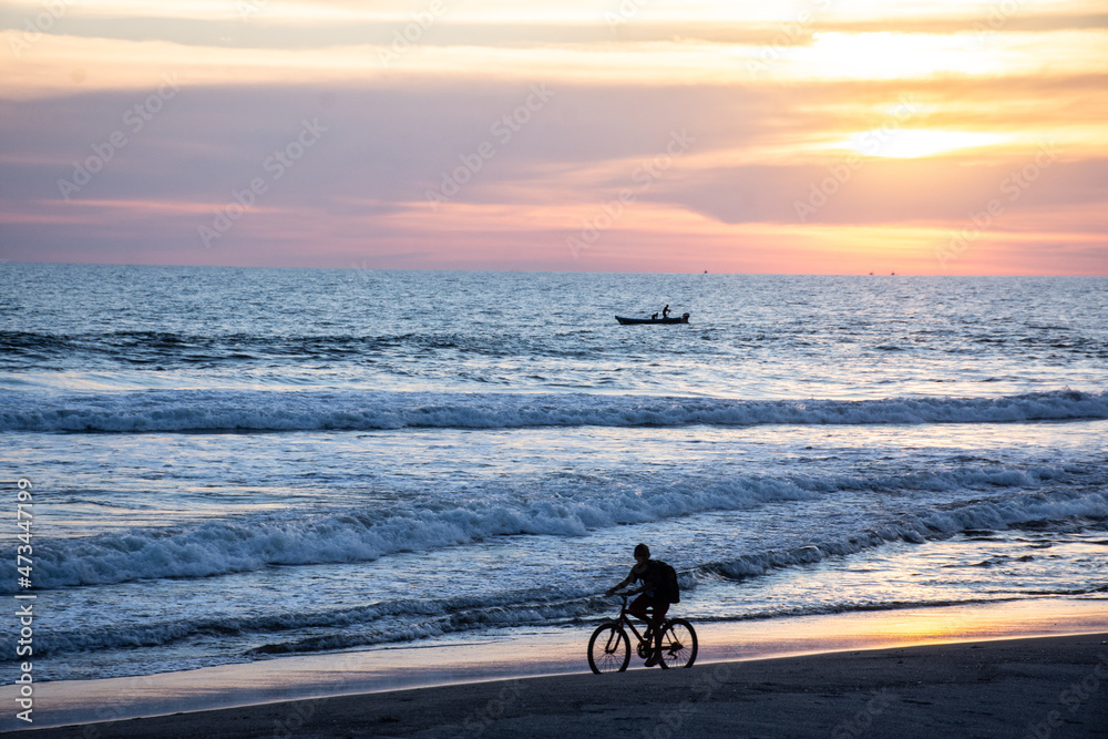 Fototapeta premium Ridding bike on the beach