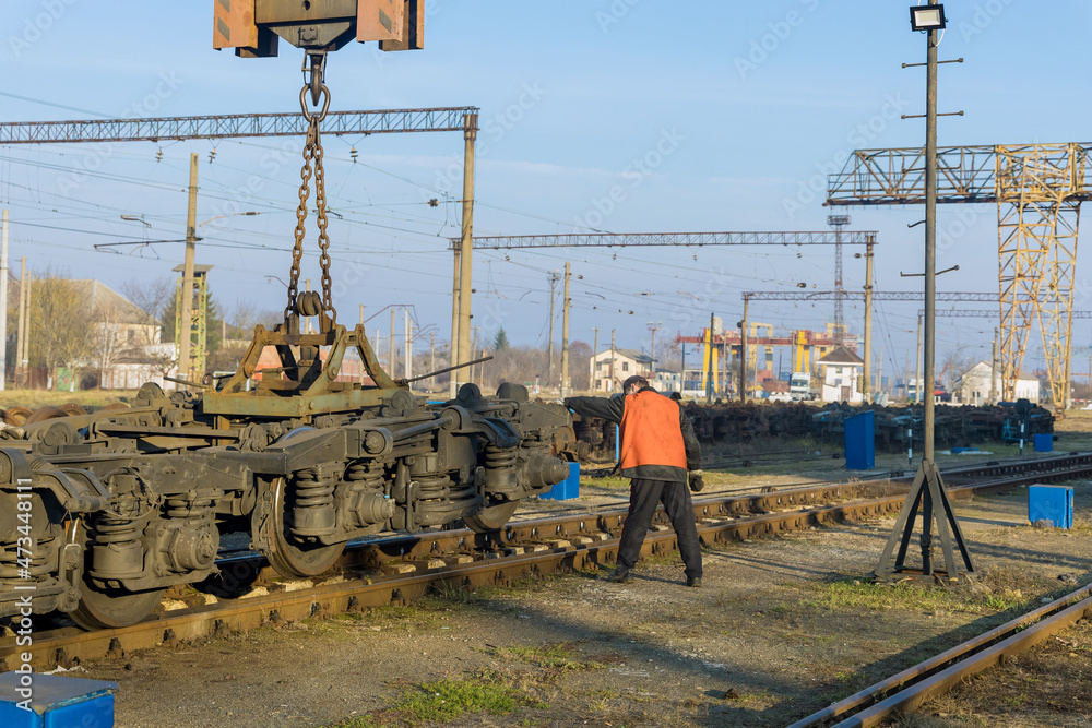 Work stations with industrial crane that raises the driving wheels for train