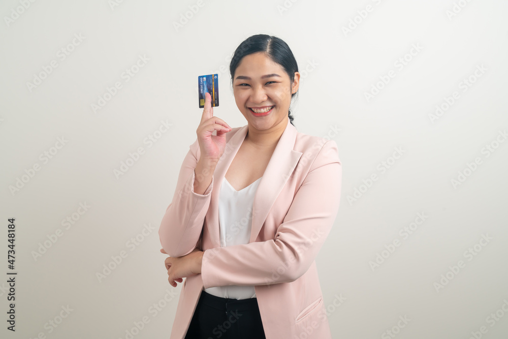 Asian woman holding credit card with white background Asian woman holding credit card with white background