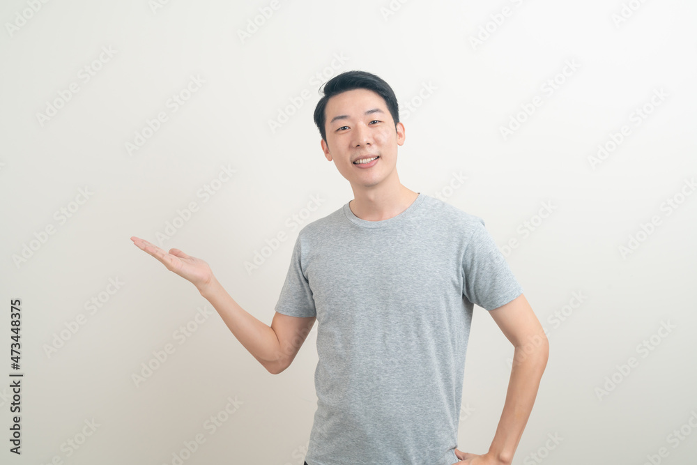 Asian man with hand pointing or presenting on white background Asian man with hand pointing or presenting on white background