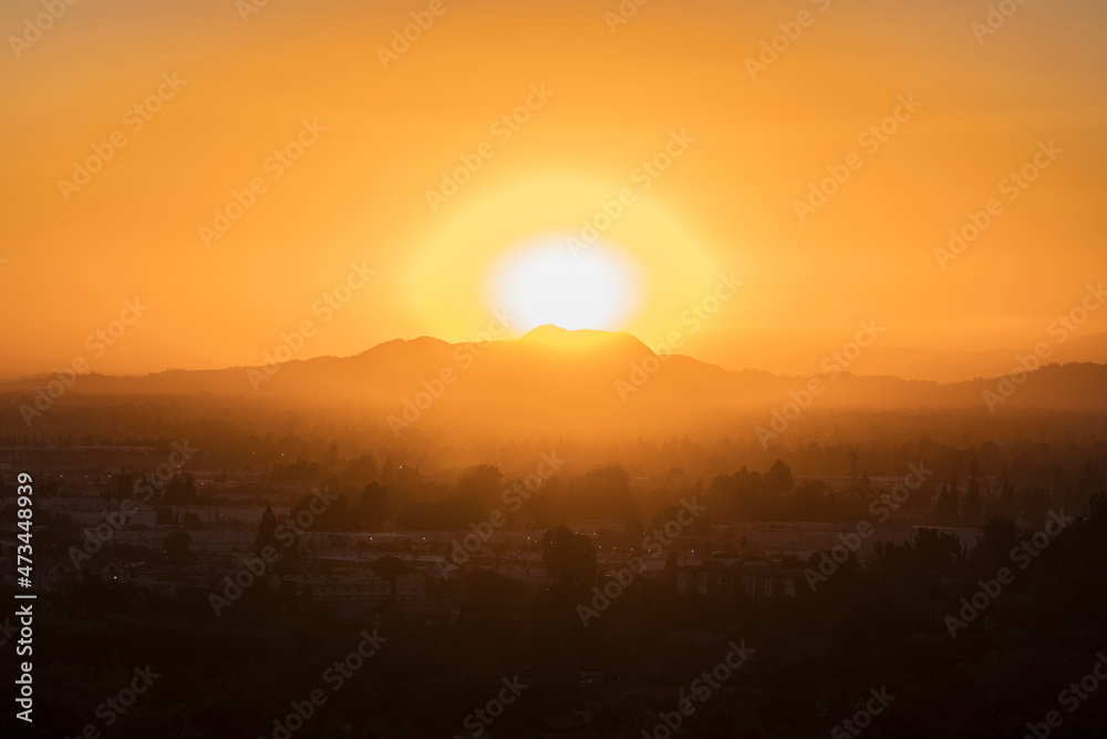 Sunrise behind Mt Hollywood and Mt Lee at the east end of the Santa Monica Mountains in the Griffith Park area of Los Angeles, California.  Photo was taken at Santa Susana Pass State Historic Park.