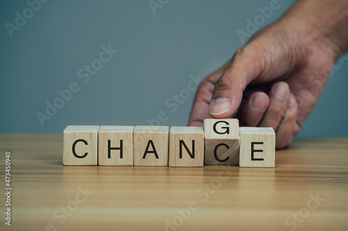 Closeup hand flips one cubes with trending the word chance to change.