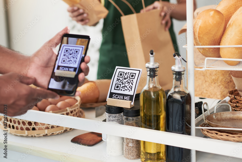 Photo & Art Print Customer scanning qr code with smartphone when ...