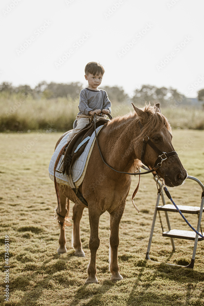 Portrait of children riding horse