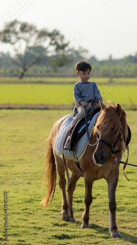 Portrait of boy riding horse © khamkula