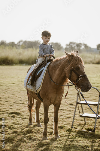 Portrait of children riding horse