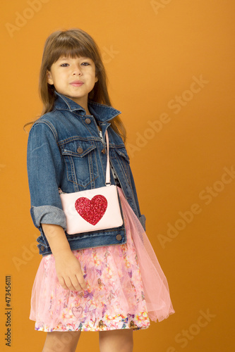 Beautiful girl in stylish outfit with shoulder bag photo