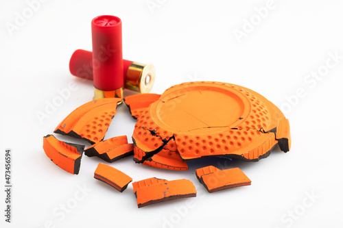 Shotgun bullet and broken clay target shooting on white background , Shooting game