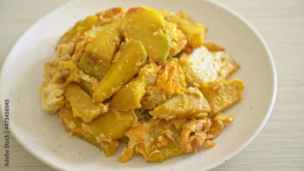 stir-fried pumpkin with egg on white plate stir-fried pumpkin with egg on white plate