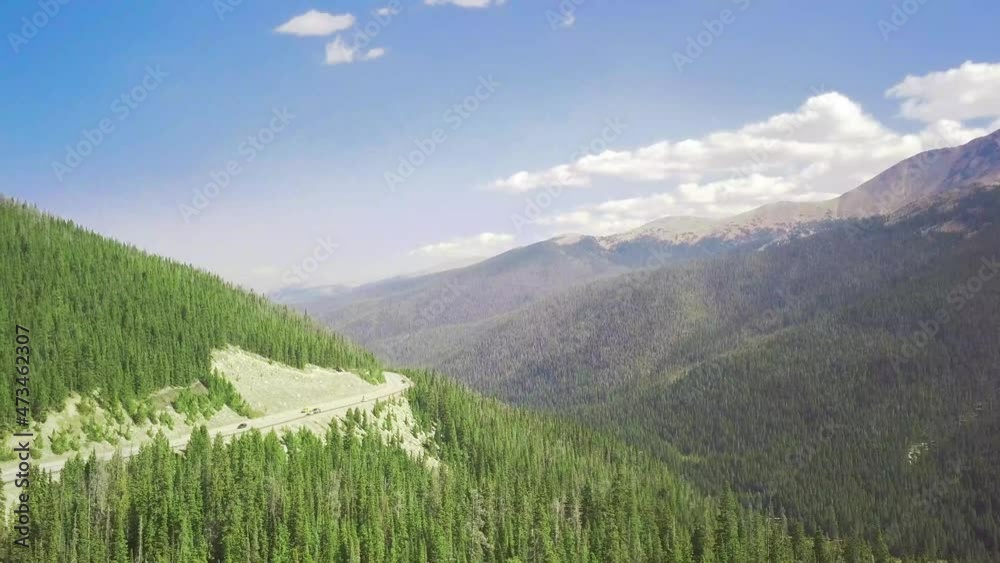 gorgeous mountain aerial overlooking a road and crisp pine trees gorgeous mountain aerial overlooking a road and crisp pine trees