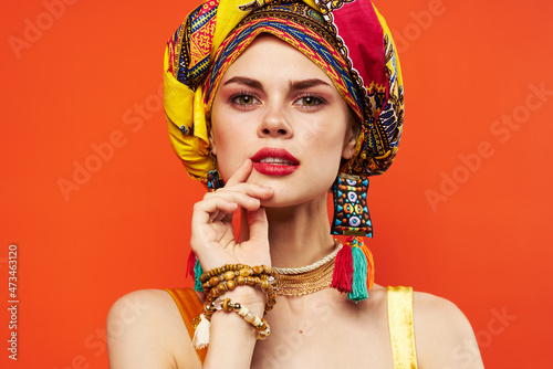 cheerful woman in multicolored turban attractive look Jewelry red background