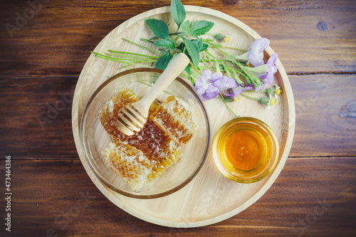 Yellow  Honeycomb in wooden plate on wooden background  Sweet Honeycomb on wooden table.