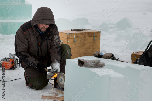 Принти на полотні The sculptor sharpens the working tool on the emery wheel