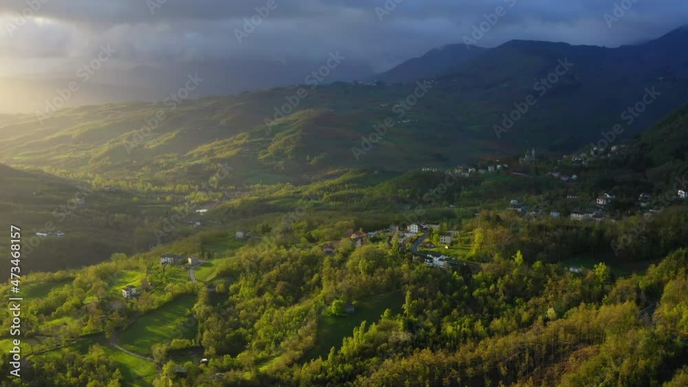 Aerial Beautiful Shot Of Houses On Green Landscape Of Hills Against Cloudy Sky - Apennine Mountains, Italy Aerial Beautiful Shot Of Houses On Green Landscape Of Hills Against Cloudy Sky - Apennine Mountains, Italy