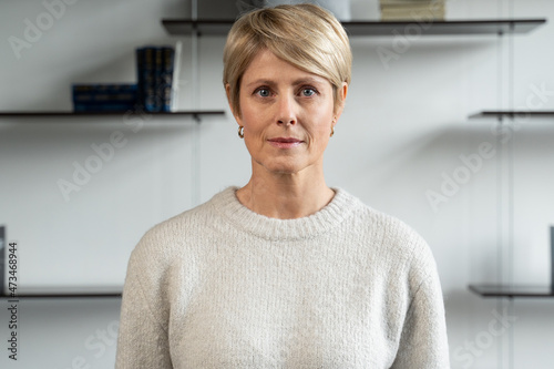 Middle-aged business woman looking into the camera, happy senior team leader, CEO, in the office, portrait