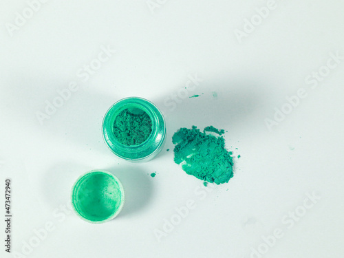Green mica powder on white isolated background