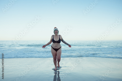 Woman having fun in the cold winter weather at the beach