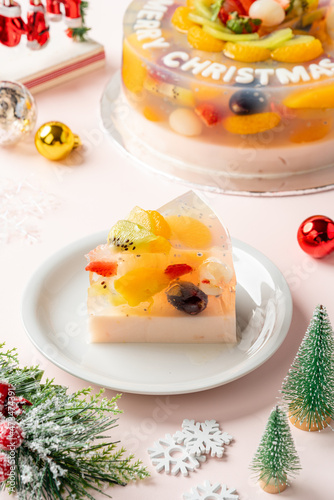 Homemade Fruit Pudding with strawberry, grape, orange, longan, kiwi and peach ingredients decorated with Christmas decorations