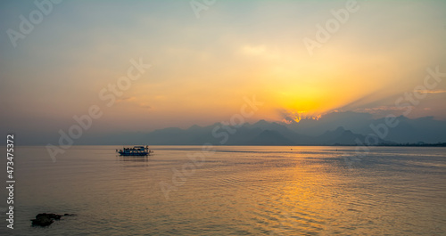 Antalya harbor over sunset sky and high mountains. Beautiful view of the Antalya Kalei  i Old town  Kaleici 