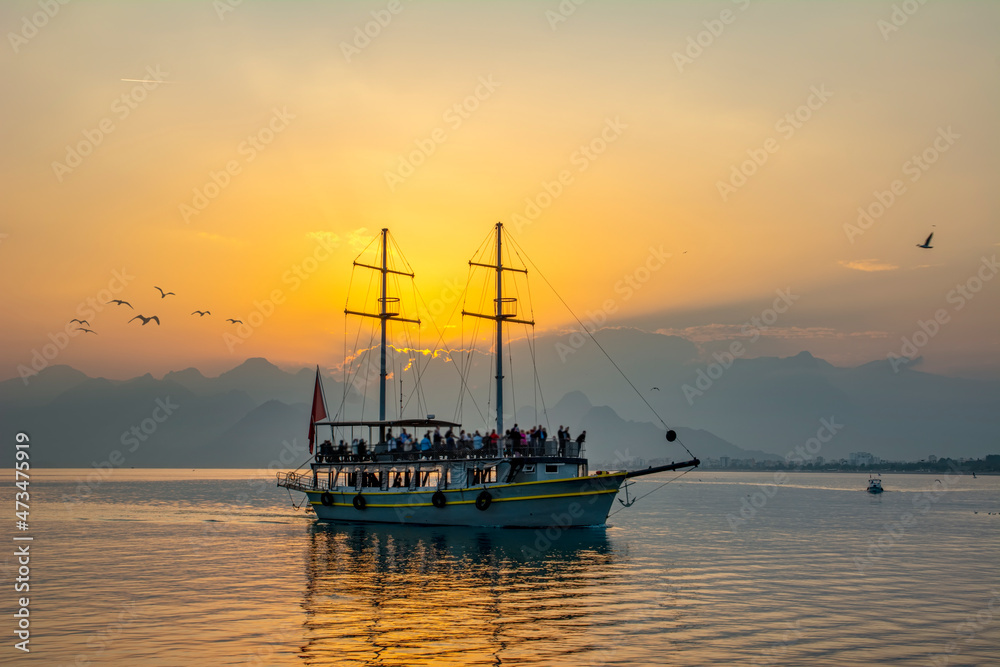 Antalya harbor over sunset sky and high mountains. Beautiful view of the Antalya Kaleiçi Old town (Kaleici) Antalya harbor over sunset sky and high mountains. Beautiful view of the Antalya Kaleiçi Old town (Kaleici)