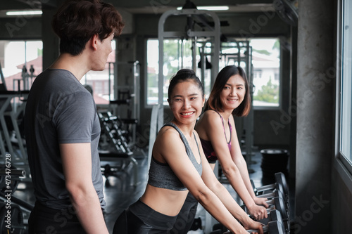 asia group friends working out or exercise and wearing sportswear in fitness or gym center, strength sporty and weight loss concept