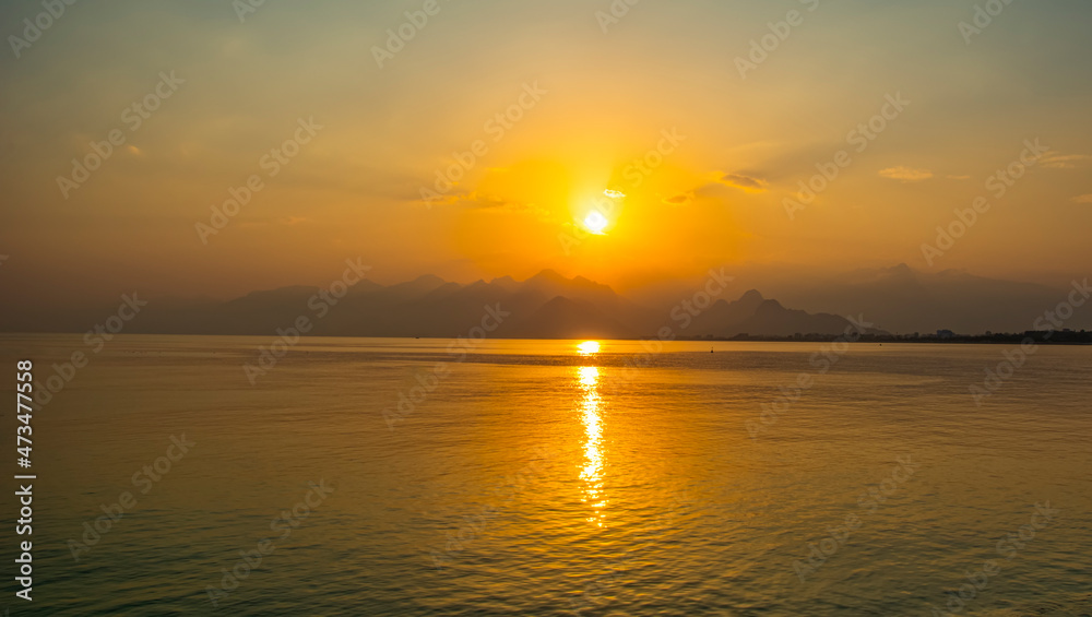 Antalya harbor over sunset sky and high mountains. Beautiful view of the Antalya Kaleiçi Old town (Kaleici)