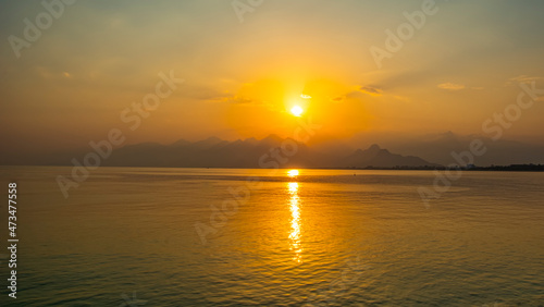 Antalya harbor over sunset sky and high mountains. Beautiful view of the Antalya Kalei  i Old town  Kaleici 