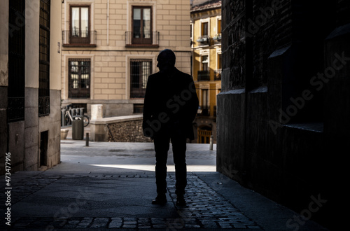 Silhouette of adult man on a narrow street of city. Shot in Madrid  Spain