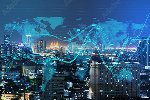 Creative glowing business chart and map hologram on blurry night city background. Business data and market concept. Double exposure.