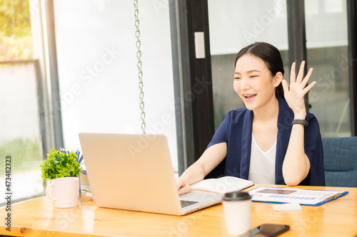 Freelance Asian woman working on tablet computers and financial graphs in a modern office. make an account analysis report real estate investment information financial and tax system concepts