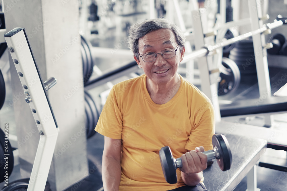 Portrait asia old man working out or exercise in fitness or gym center with mini dumbbell, Strength sporty and good healthy concept Portrait asia old man working out or exercise in fitness or gym center with mini dumbbell, Strength sporty and good healthy concept
