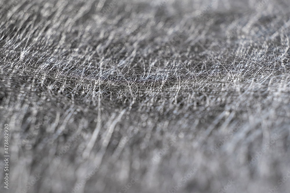 Textured background from interlacing of thin silver threads. Close-up of silver felt. Shallow depth of field Textured background from interlacing of thin silver threads. Close-up of silver felt. Shallow depth of field