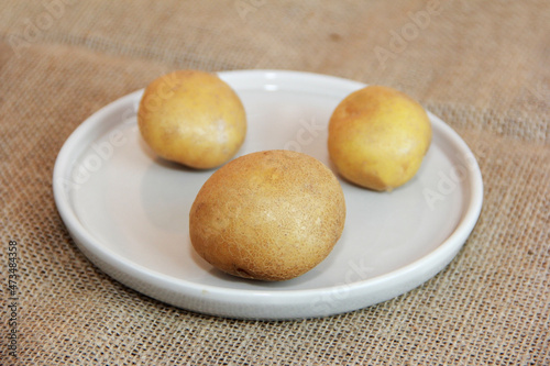 Round fruits of natural yellow potatoes