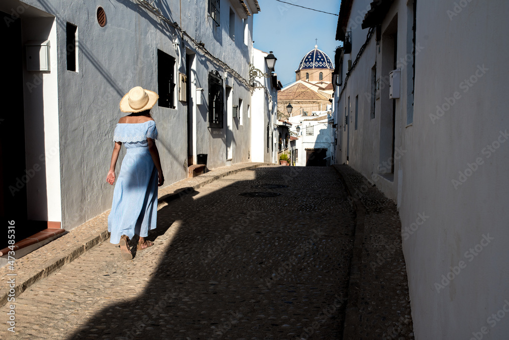 Anonymous woman on street of old coastal town in Altea Anonymous woman on street of old coastal town in Altea
