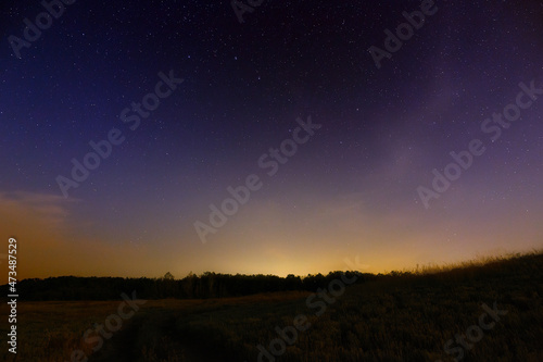 Star night sky with light pollution from the city.