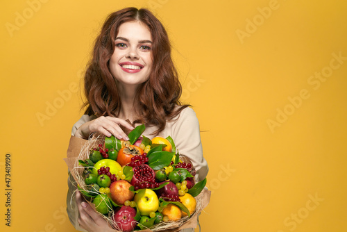 pretty woman beige coat fruit bouquet in hands present isolated background