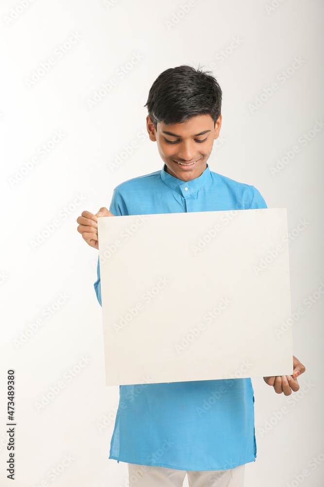Indian little child in traditional wear and showing white board. Indian little child in traditional wear and showing white board.