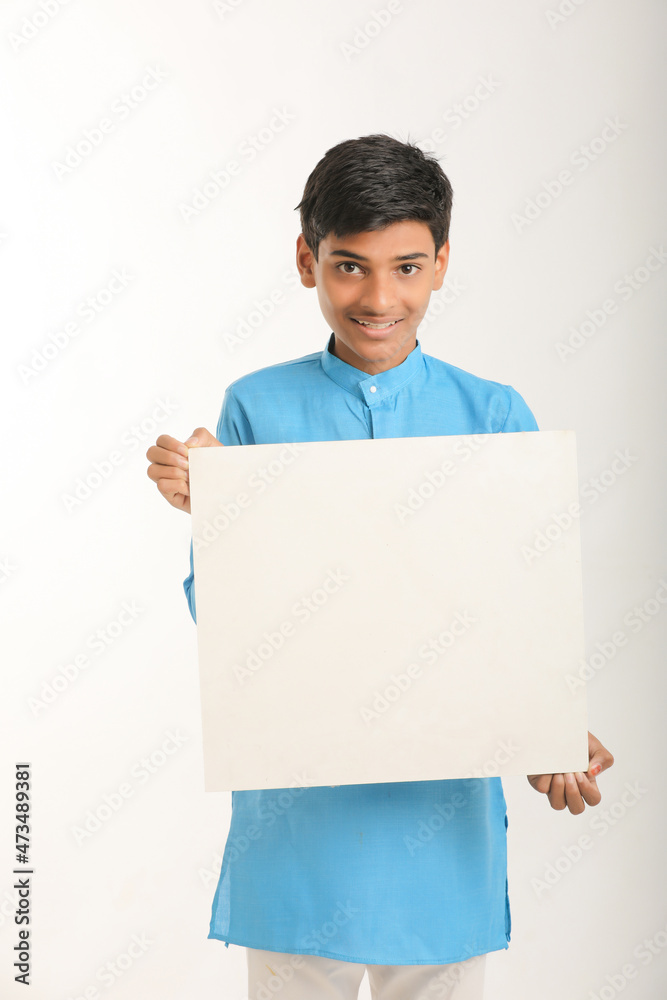 Indian little child in traditional wear and showing white board. Indian little child in traditional wear and showing white board.