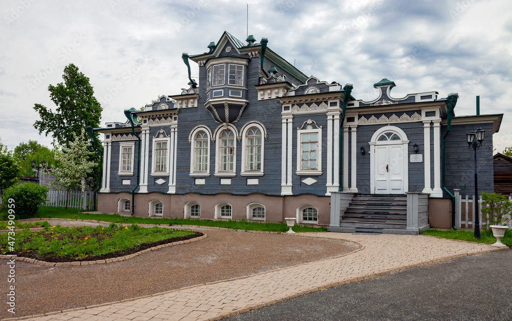 Facade of the wooden house of the Decembrist Sergei Trubetskoy 1854-56 in Irkutsk in summer in cloudy weather.