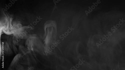 white smoke on a black background. Slow motion. Vape smoke