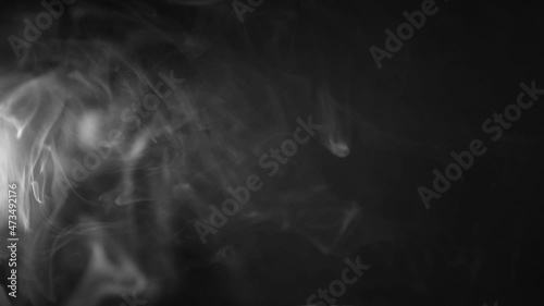white smoke on a black background. Slow motion. Vape smoke