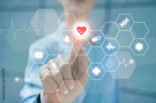 Businesswoman touching heart shape on digital display