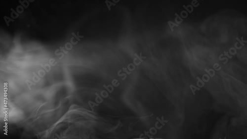 white smoke on a black background. Slow motion. Vape smoke