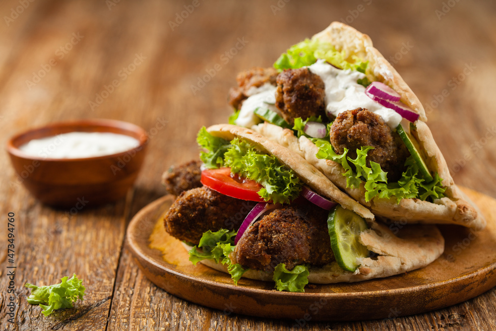 Kebab, kofta in pita, bun. Traditional southern European dish. Front view. Kebab, kofta in pita, bun. Traditional southern European dish. Front view.