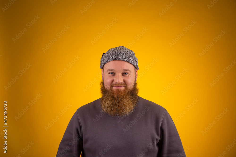 man with beard smiling on yellow background man with beard smiling on yellow background