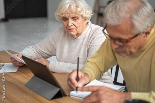 Senior husband and wife paying bills online
