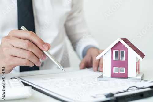 Agents working in real estate investment Hold the key home Ready home insurance signing contracts in accordance with the home buying insurance agreements approving purchases for clients