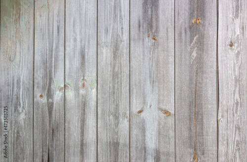 Old grey wooden background with cracks and scratches in vintage style