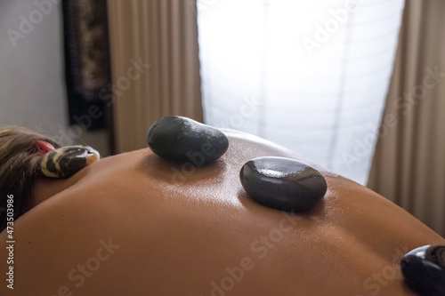 Girl performs massage on the ground.