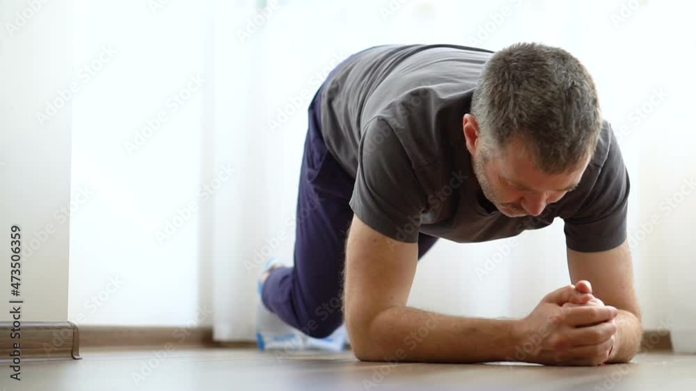 Handsome man doing abs exercises at home during quarantine. Concept of healthy life, home fitness. Handsome man doing abs exercises at home during quarantine. Concept of healthy life, home fitness.